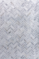 Plakat background of grey and white marble tile in herringbone pattern