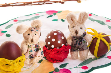 Easter composition with couple of  funny toy rabbits and eggs.