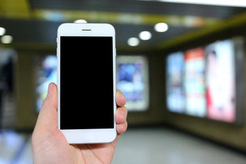 Poster - Hand holding smartphone with cinema background