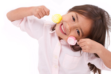 Wall Mural - cute little girl playing, eating sugar jelly sweet candy