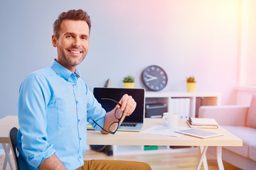 Wall Mural - Portrait of happy man working from home office