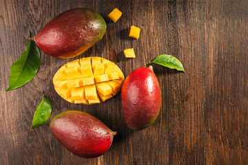 Wall Mural - Slised ripe mango on wooded board.