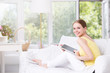 © BestForYou - Happy woman with tablet on couch.