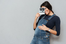 Pregnant Smiling Woman Showing Ultrasound Scans