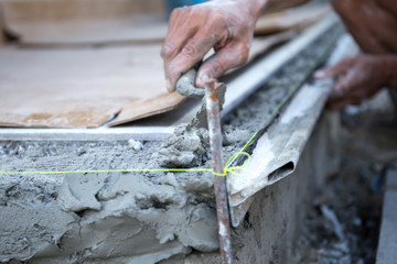 Wall Mural - man shape the edge of the floor with plasterer concrete cement