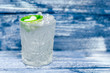 Transparent glass with tonic, with ice and lime