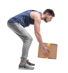 Wall Mural - Posture concept. Man lifting heavy cardboard box against white background