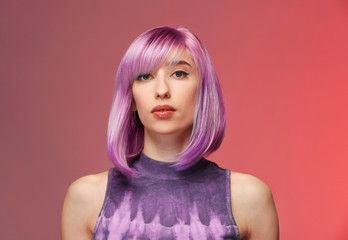beautiful young woman with dyed hair on color background