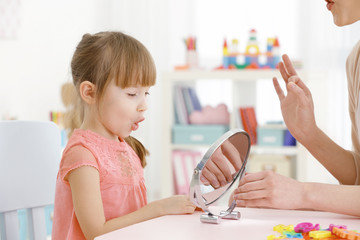 Wall Mural - Cute little girl at speech therapist office