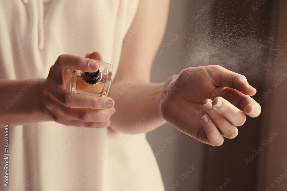 Beautiful young woman with bottle of perfume at home, closeup - obrazy, fototapety, plakaty 