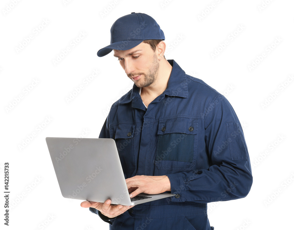 Handsome auto mechanic with laptop on white background