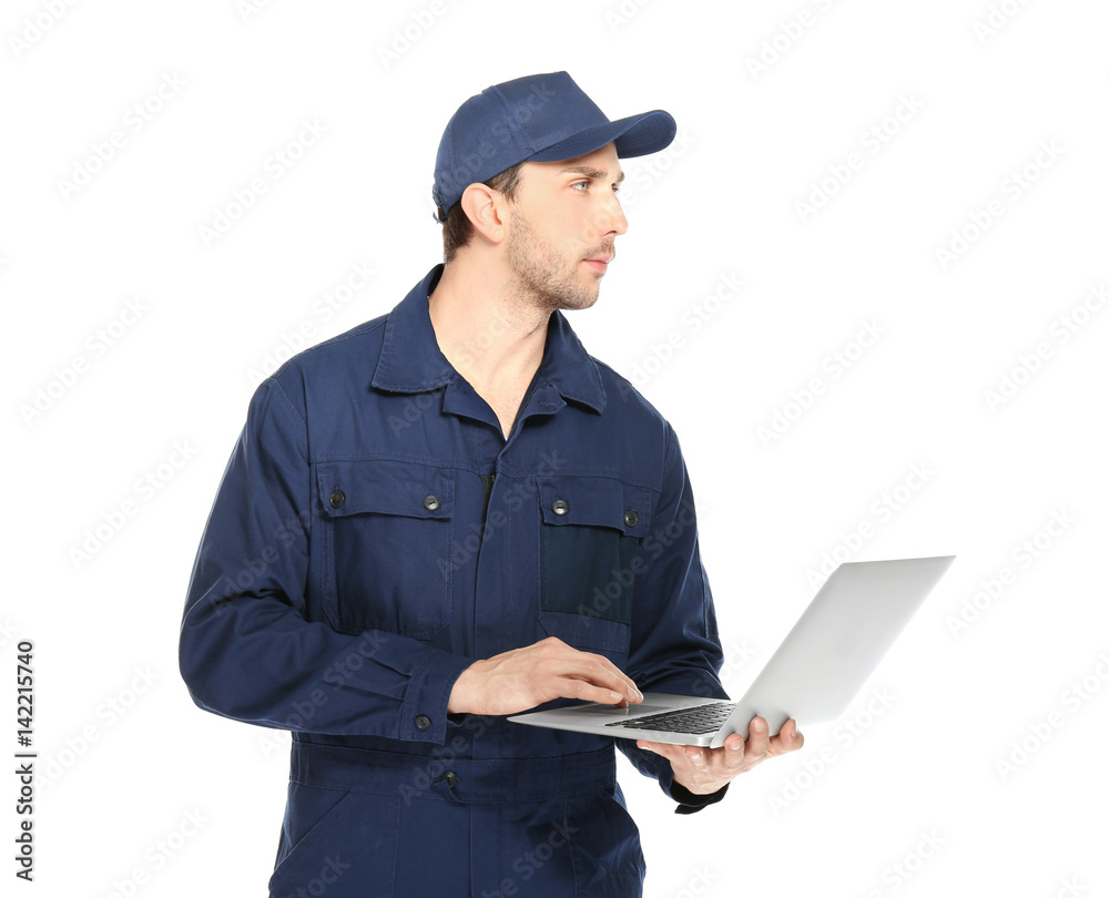 Handsome auto mechanic with laptop on white background