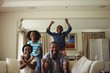 © WavebreakMediaMicro - Parents and kids having fun in living room