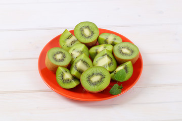 Wall Mural - plate of kiwi halves and quarters