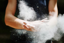 Climber Woman Coating Her Hands In Powder Chalk Magnesium. Ready For Climbing