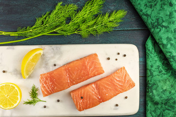 Two slices of salmon on dark background with copyspace