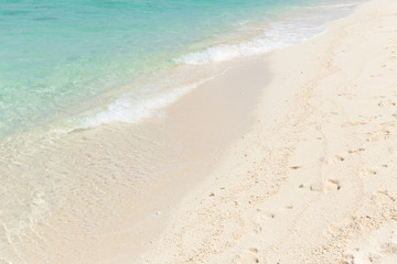 Wall Mural - white sand blue emerald sea beach for background.