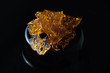 © roxxyphotos - Marijuana oil concentrate aka shatter isolated on black background
