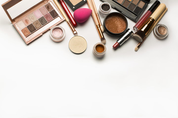 Sticker - Flat lay of eyeshadow palettes,makeup brushes and lipstick over a white background