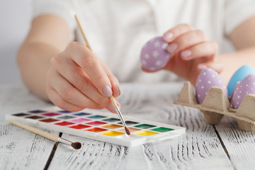 Wall Mural - woman painting Easter eggs