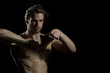 © Tverdokhlib - Ax in the hands of young man on black background. Danger or manual work with wood. Trendy man with thick beard and mustache is holding battle ax. Woodman goes felling
