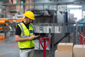 Wall Mural - Factory worker using a digital tablet