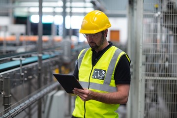 Wall Mural - Factory worker using a digital tablet