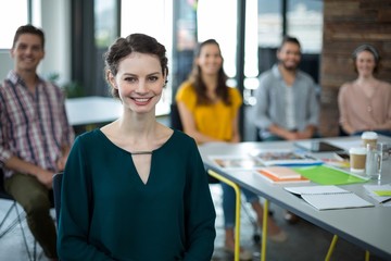 Wall Mural - Smiling graphic designers sitting in office