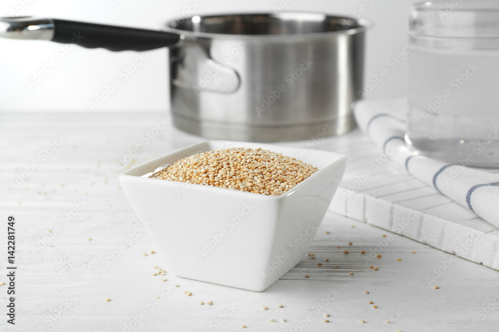 Bowl with quinoa seeds on kitchen table