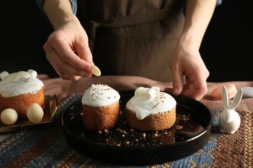 Wall Mural - Woman decorating Easter cakes, closeup