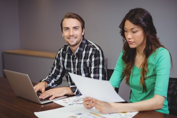 Wall Mural - Male and graphic designers working together in conference room