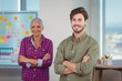 © WavebreakMediaMicro - Portrait of business executives standing with arms crossed