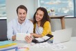 © WavebreakMediaMicro - Smiling graphic designers sitting at table