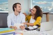 © WavebreakMediaMicro - Smiling graphic designers having a laugh together