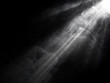 abstract beautiful rays of light with smoke on black background.
