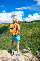 Wall Mural - Hiking woman looking at inspirational mountains landscape