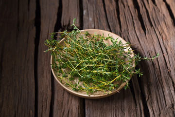 Wall Mural - Thyme fresh herb on old wood background