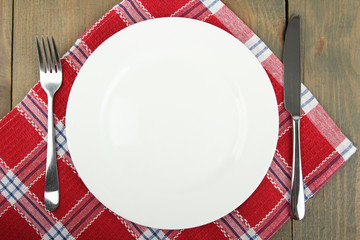 White plate, fork, knife and  napkin