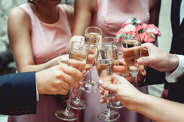 Wall Mural - People hold in hands glasses with white wine. wedding party.