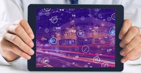 Poster - Businessman holding tablet with screen of Night city with connectors