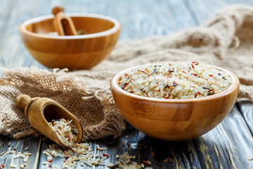 Wall Mural - Wooden bowl with a mixture of different varieties of rice.