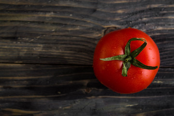 Tomato on a wooden background in rustic style