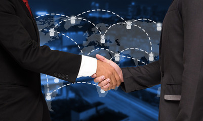 Wall Mural - double exposure of businessman handshake with world map social media network connection, successful 