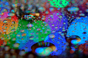 Wall Mural - Rain drop on the mirror with light bokeh background