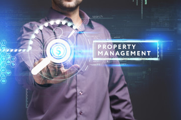 Business, Technology, Internet and network concept. Young businessman working on a virtual screen of the future and sees the inscription: Property management