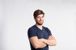 © Halfpoint - Handsome fitness man in gray t-shirt, studio shot.