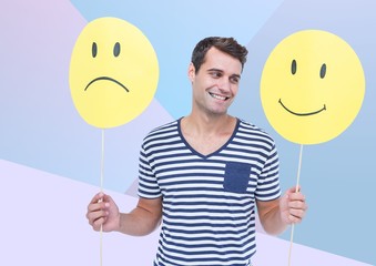 Man holding happy and sad face against blue background