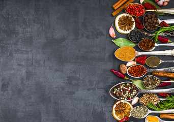 Various spices spoons on stone table. Top view .