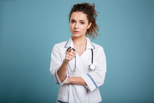 Beautiful Serious Female Doctor Pointing At Camera