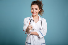 Smiling Woman Doctor Or Nurse Showing Thumbs Up Gesture